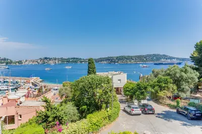 arial view of a city with a river and cars at BELLE DARSE AP4454 By Riviera Holiday Homes in Villefranche-sur-Mer