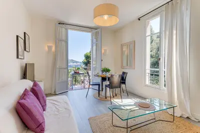 a living room with a couch and a glass table at BELLE DARSE AP4454 By Riviera Holiday Homes in Villefranche-sur-Mer