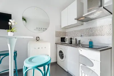 a kitchen with a sink and a washing machine at Cocon Place Massena, Cours Saleya et Mer in Nice