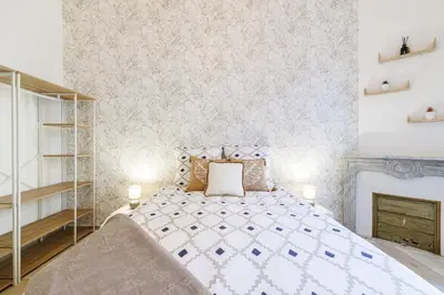 a bedroom with a bed and a fireplace at 36 STALNGRAD - Appartement spacieux - Le Port - 6 pers in Nice