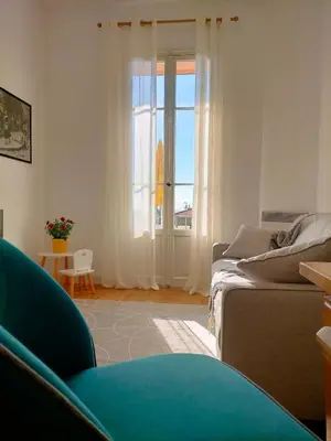 a living room with a couch and a window at L'Essentiel à Nice in Nice