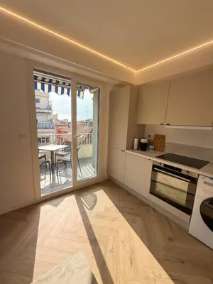 a kitchen with a view of a table and a balcony at appartement port de Nice 4pers emplacement idéal in Nice