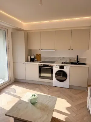 a kitchen with white appliances and a table at appartement port de Nice 4pers emplacement idéal in Nice