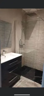 a bathroom with a shower and a white sink at Vacances à Nice in Nice