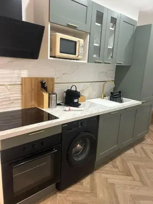 a kitchen with a washing machine and a microwave at MASSENA 36 in Nice