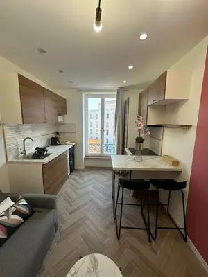 a kitchen with a couch and a table in a room at MOON - 43 in Nice