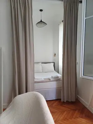 a bed sitting in a room with a window at Studio Centre-Ville Nice in Nice