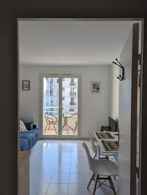 a living room with a table and a couch at Nice center - 2 person apartment in Nice