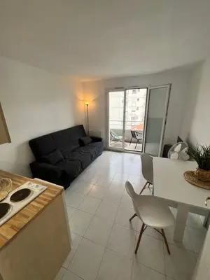 a living room with a couch and a table at Nice center - 2 person apartment in Nice