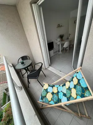 a couch on a balcony with a table and chairs at Nice center - 2 person apartment in Nice