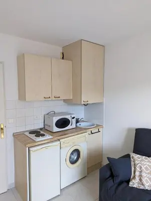 a kitchen with a washing machine and a microwave at Nice center - 2 person apartment in Nice