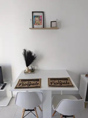 a white desk with two white chairs in a room at Nice center - 2 person apartment in Nice