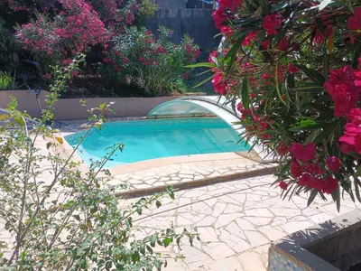 a small swimming pool in a garden with flowers at Chalet at Villa Don Quijote Nice in Nice