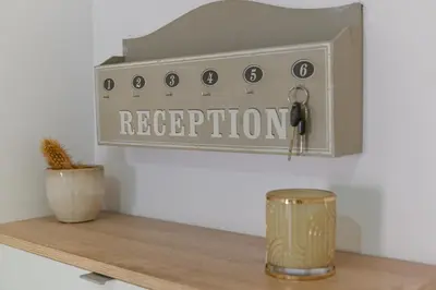 a shelf with a sign that reads reception at Le Duplex in Villefranche-sur-Mer