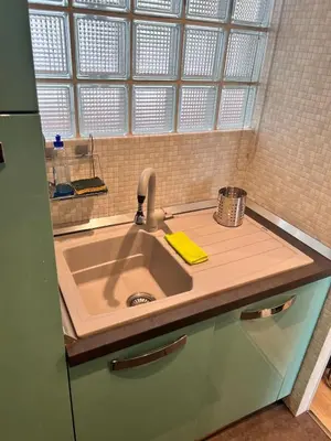 a kitchen counter with a sink and a window at Studio at the heart of Carre D'or 2 mins Sea Wi-fi in Nice
