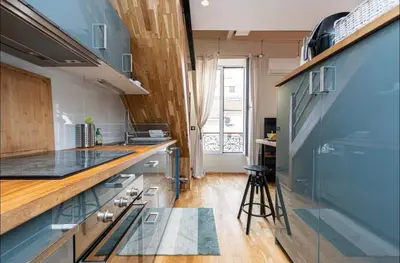 a kitchen with blue cabinets and a counter at Duplex center of Nice with AC in Nice