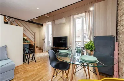 a living room with a glass table and chairs at Duplex center of Nice with AC in Nice