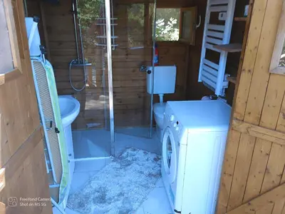 a bathroom with a toilet and a washing machine at Grand Chalet at Villa Don Quijote Nice in Nice