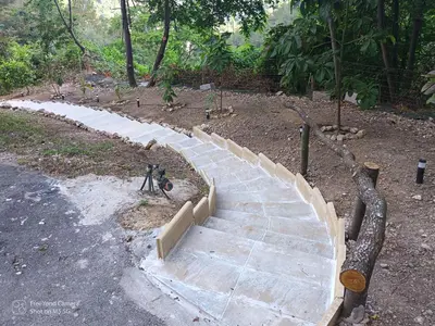 a stone walkway in a park with a bike on it at Grand Chalet at Villa Don Quijote Nice in Nice