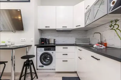 a kitchen with white cabinets and a washing machine at 1 bed, center of Nice with AC in Nice