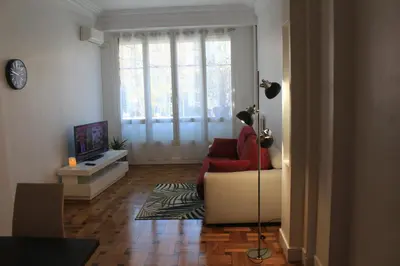 a living room with a red couch and a window at LE REX Nice in Nice