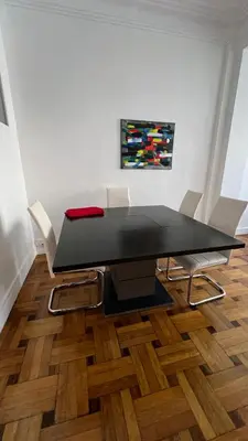 a black table and chairs in a room at LE REX Nice in Nice
