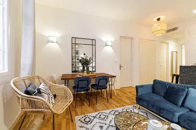 a living room with a blue couch and a table at Chic & Cozy 2 Bdr Heart of the Old Town in Nice