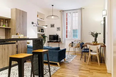 a living room with a blue couch and a table at Chic & Cozy 2 Bdr Heart of the Old Town in Nice