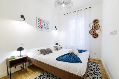 a white bedroom with a bed and a window at Chic & Cozy 2 Bdr Heart of the Old Town in Nice
