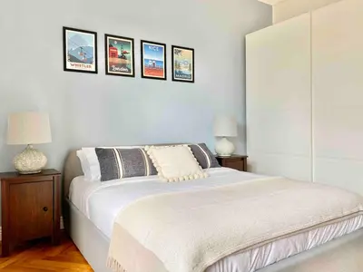 a bedroom with a bed with three pictures on the wall at Nice Sea View 2 bedroom apartment in Nice