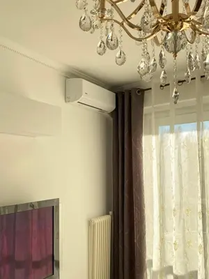 a chandelier hanging from a ceiling next to a window at Appart T2 refait à neuf 50m2 in Nice