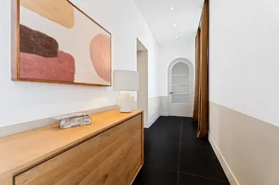 a hallway with a table with a lamp and a painting at Nice Renting - VICTOR - Historic Palace Luxury 3 Bedrooms in Nice