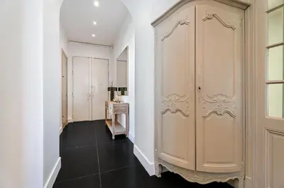 a hallway with white cabinets and a black floor at Nice Renting - VICTOR - Historic Palace Luxury 3 Bedrooms in Nice