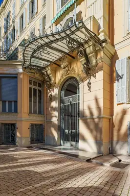 an entrance to a building with an iron gate at Nice Renting - VICTOR - Historic Palace Luxury 3 Bedrooms in Nice
