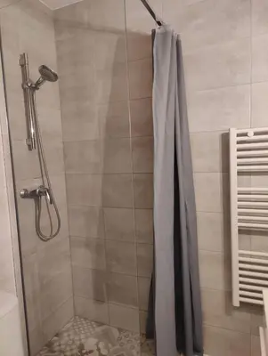 a bathroom with a shower with a shower curtain at Carré d'Or - Studio lumineux à 5 minutes de la plage in Nice