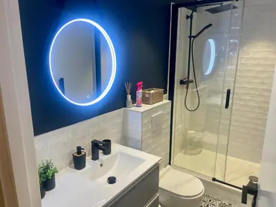 a bathroom with a sink and a shower with a mirror at Suite ana in Nice