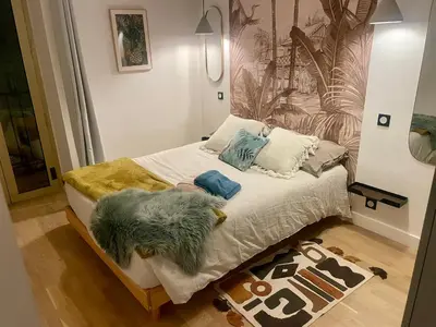 a bedroom with a bed with pillows and a rug at Suite ana in Nice
