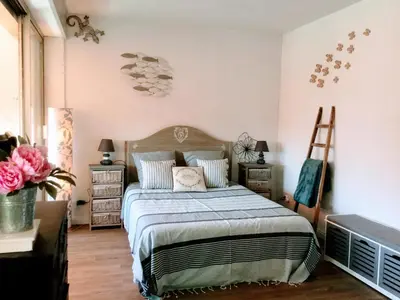 a bedroom with a bed and two night stands at Echappèe belle en bord de mer in Cagnes-sur-Mer