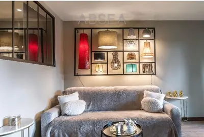 a living room with a couch and a table at Nice Absea Belles Terres Studio in Nice