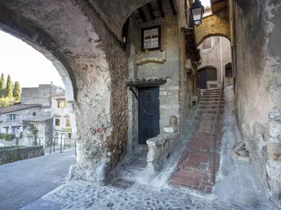 an old building with a door in a street at Apartment Cagnes Provencal by Interhome in Cagnes-sur-Mer