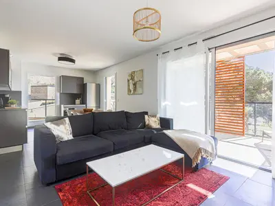 a living room with a couch and a table at Apartment Prestige view by Interhome in Èze