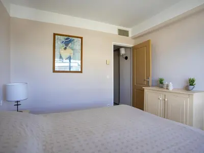 a bedroom with a bed and a picture on the wall at Apartment Heliotel Marine-2 by Interhome in Saint-Laurent-du-Var