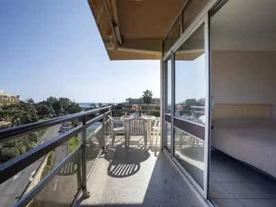 a balcony with a bed and a view of the ocean at Apartment Heliotel Marine-2 by Interhome in Saint-Laurent-du-Var