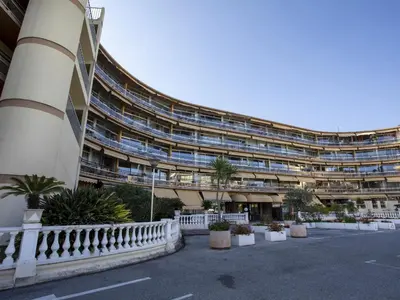 a large building with plants in front of it at Apartment Heliotel Marine-2 by Interhome in Saint-Laurent-du-Var