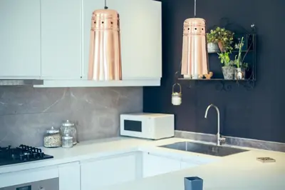 a kitchen with white cabinets and a counter top at Blue appart - centre ville - gare in Nice