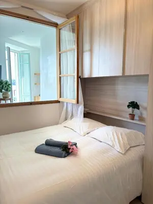 a large bed with a teddy bear sitting on it at NEPTUNE AP4453 By Riviera Holiday Homes in Villefranche-sur-Mer