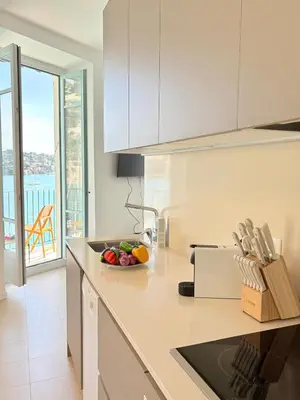 a kitchen with a bowl of fruit on a counter at NEPTUNE AP4453 By Riviera Holiday Homes in Villefranche-sur-Mer