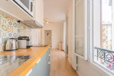 a kitchen with a counter top and a window at Studio Cosy à Nice in Nice