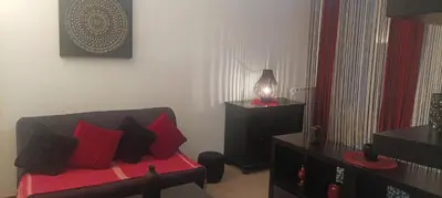 a living room with a red and black couch and a lamp at F1 Cozy & Stylish in Hyper-Centre in Nice