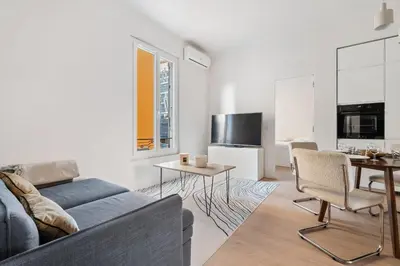 a living room with a couch and a table at Appartement Ostave - Welkeys in Nice